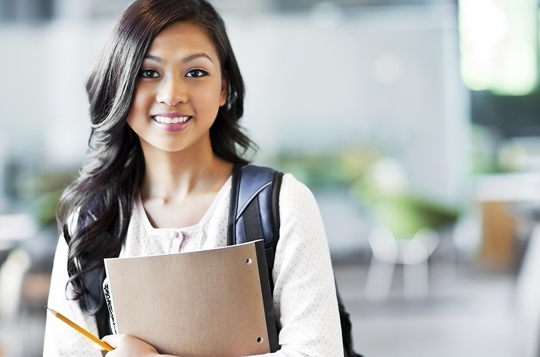  A women smiling holding book in hand